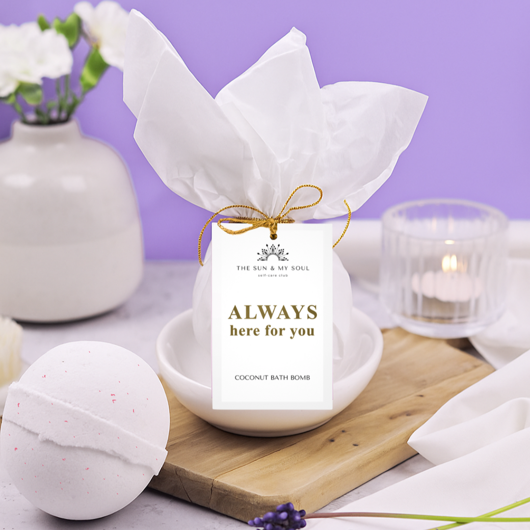 Coconut bath bomb with a decorative tag on a wooden board against a purple background