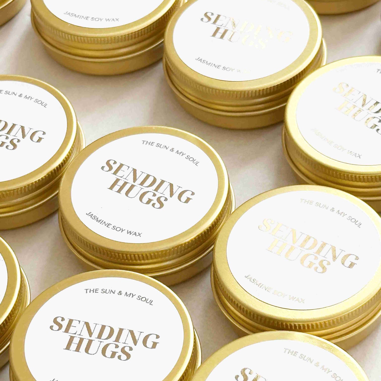 Jars of jasmine soy wax with 'Sending Hugs' text on lids.
