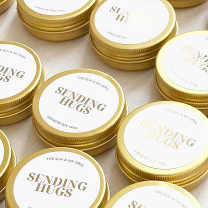 Jars of jasmine soy wax with 'Sending Hugs' text on lids.
