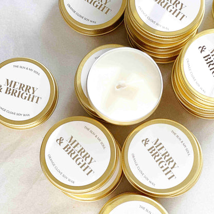 Christmas Candle tins with 'Merry & Bright' labels on a light surface