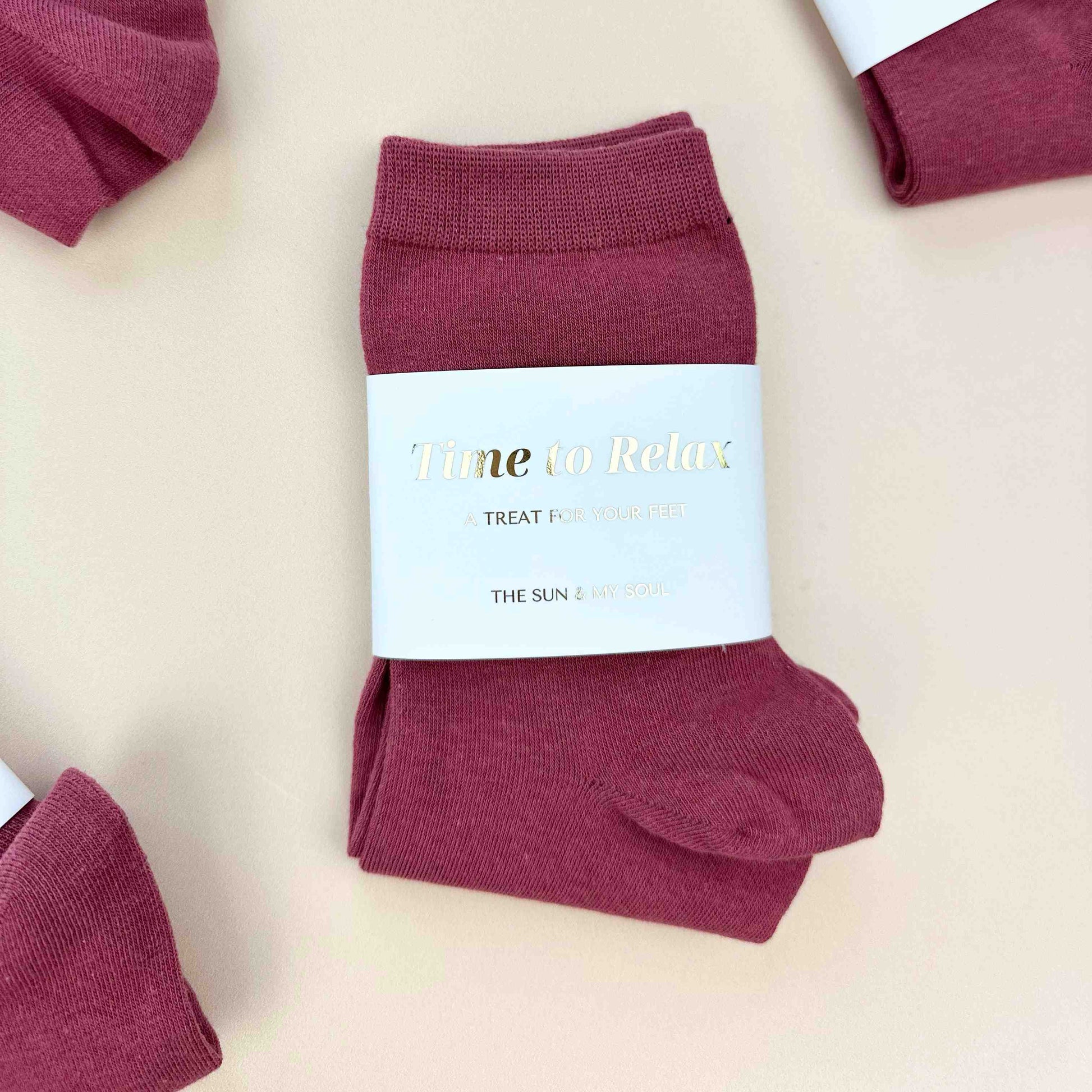 Maroon socks with a label on a beige background