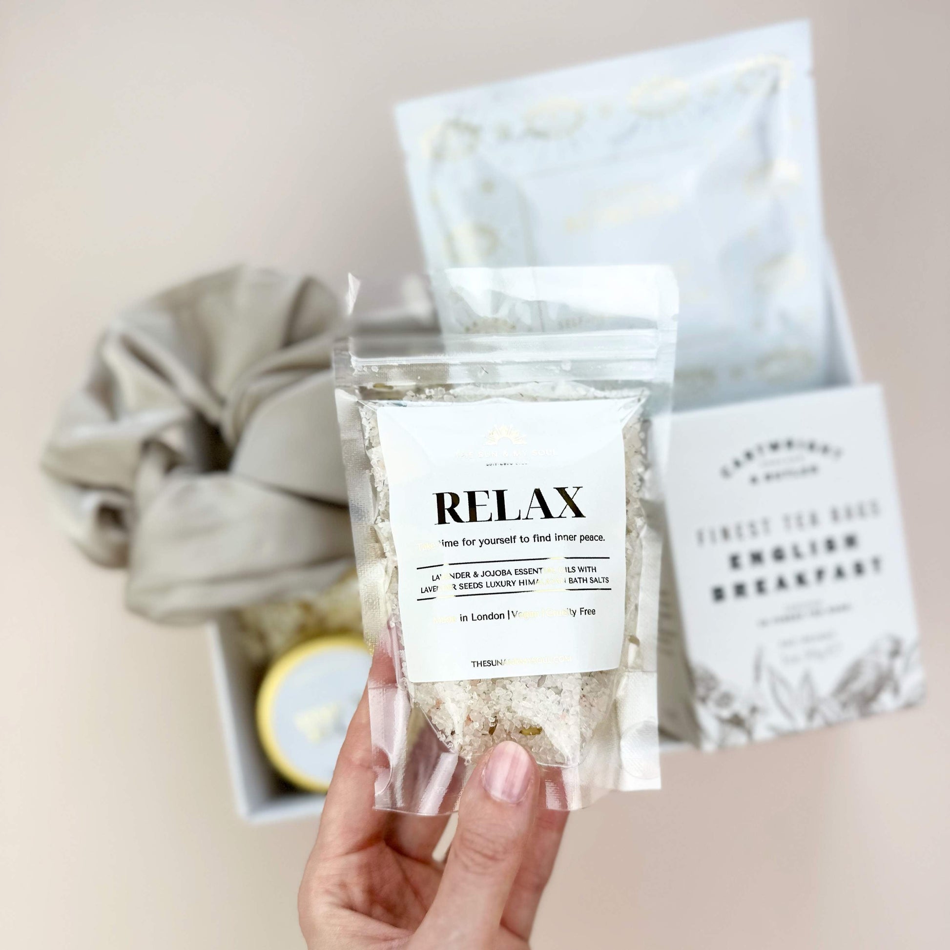 Hand holding a package labeled 'Relax' with a blurred background