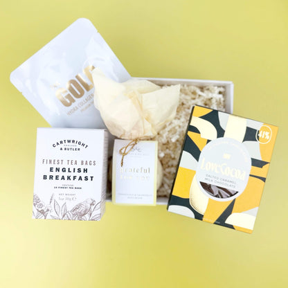 Tea packaging with a decorative item on a yellow background