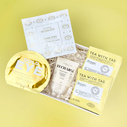 Packaged tea products with 'Gold Eye' and 'Tea with Tae' branding on a yellow background