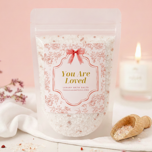 Bath salts packaging with 'You Are Loved' text on a pink background