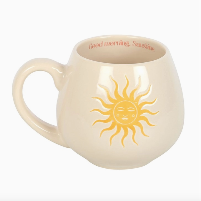 Beige mug with sun design and 'Good morning, Sunshine' text on a white background