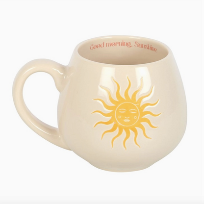 Beige mug with sun design and 'Good morning, Sunshine' text on a white background