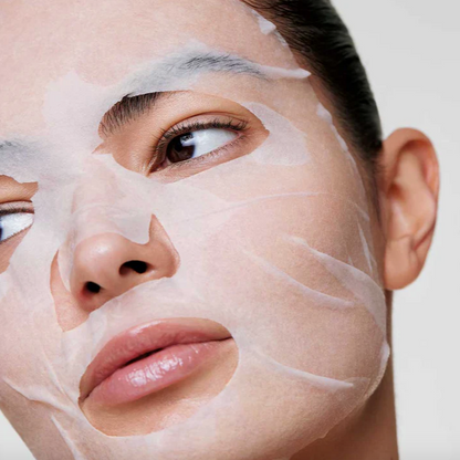 Person applying a face mask with a neutral background