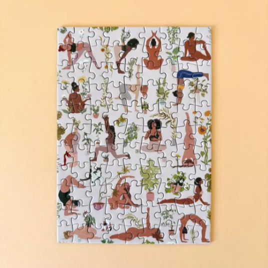 Jigsaw puzzle with illustrated yoga figures on a beige background
