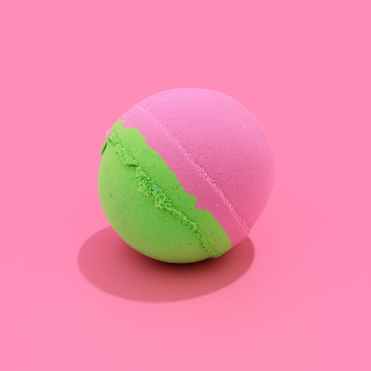 Pink and green bath bomb on a pink background